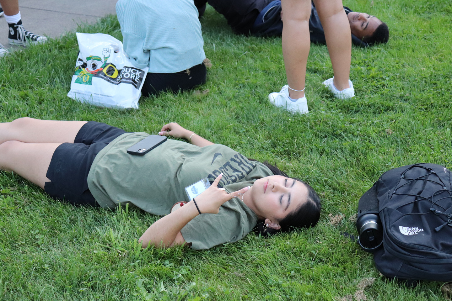 2024 SLTer, Cassy lays on the grass after an activity