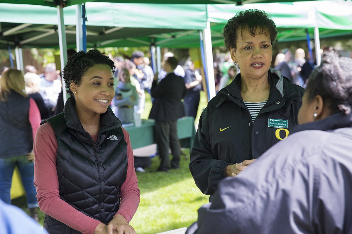 Two faculty talking at an information fair