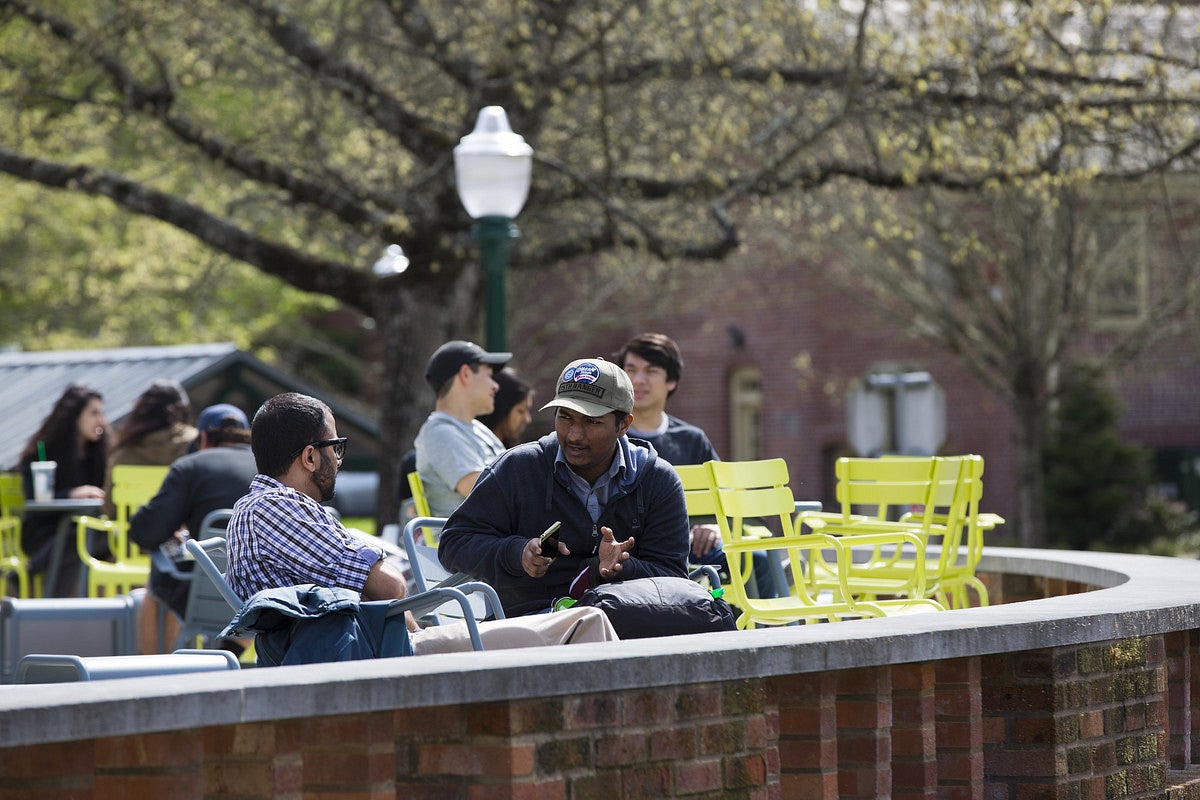 Two men sitting outside the Erb Memorial Union