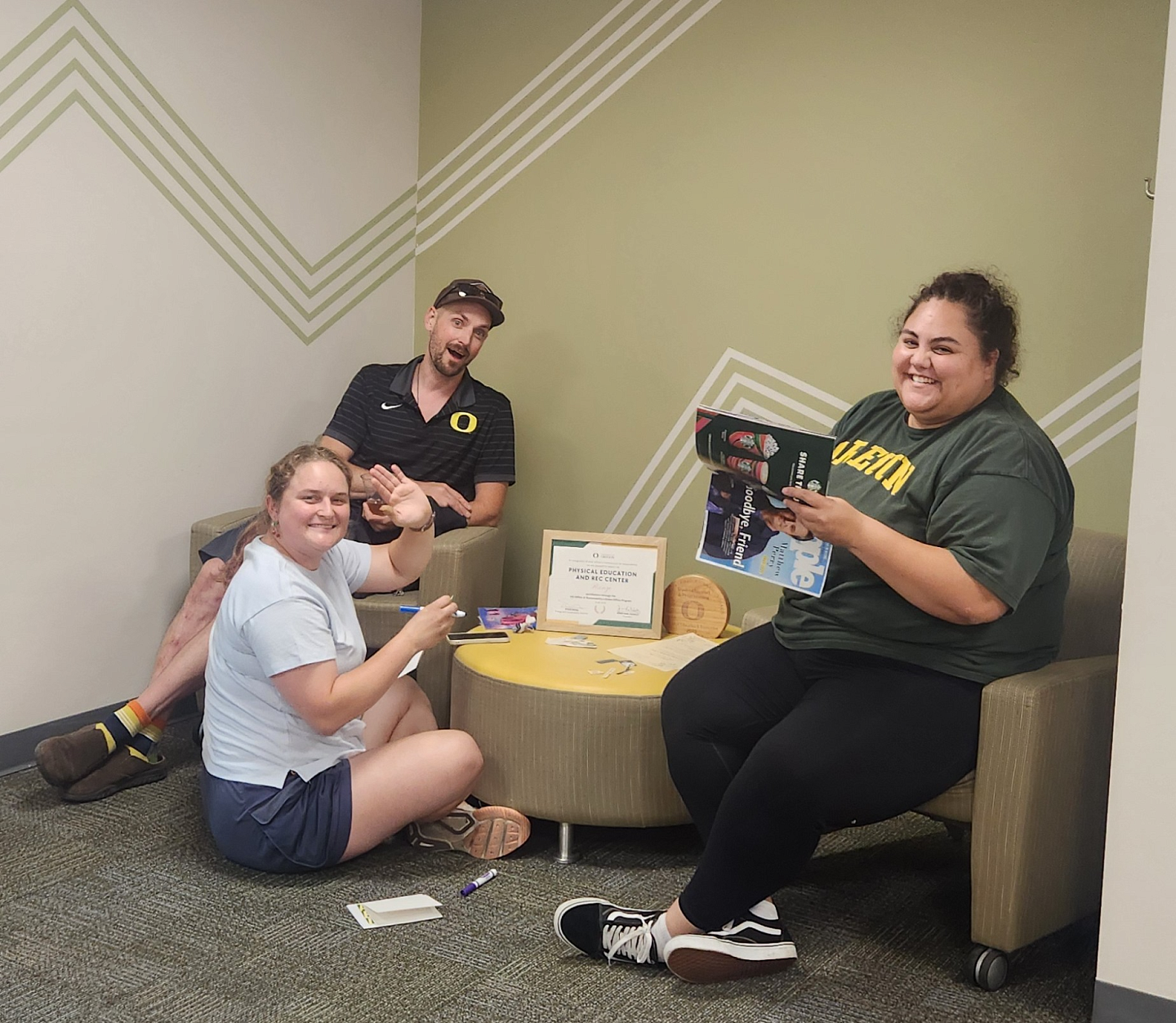 Three colleagues making notecards of support for others.