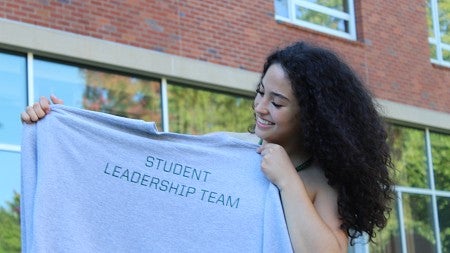 SLT Student with a Sweatshirt that says SLT