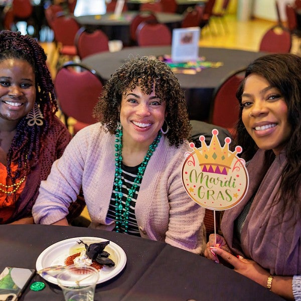 Women smiling and seated at table