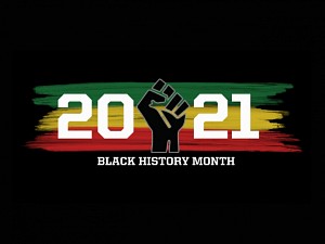 black background with the date "2021" written on top of green, yellow and red paint with a closed fist in the middle