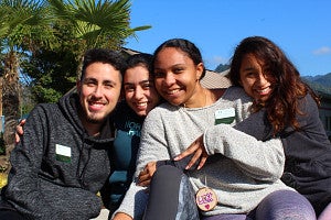 LACE love new student retreat Four students hugging each other outside