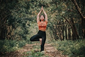 wellness lace pages yoga woman doing yoga in the woods