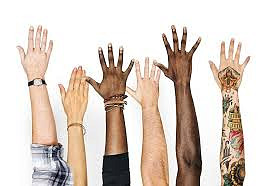 outstretched hands of people with different skin colors