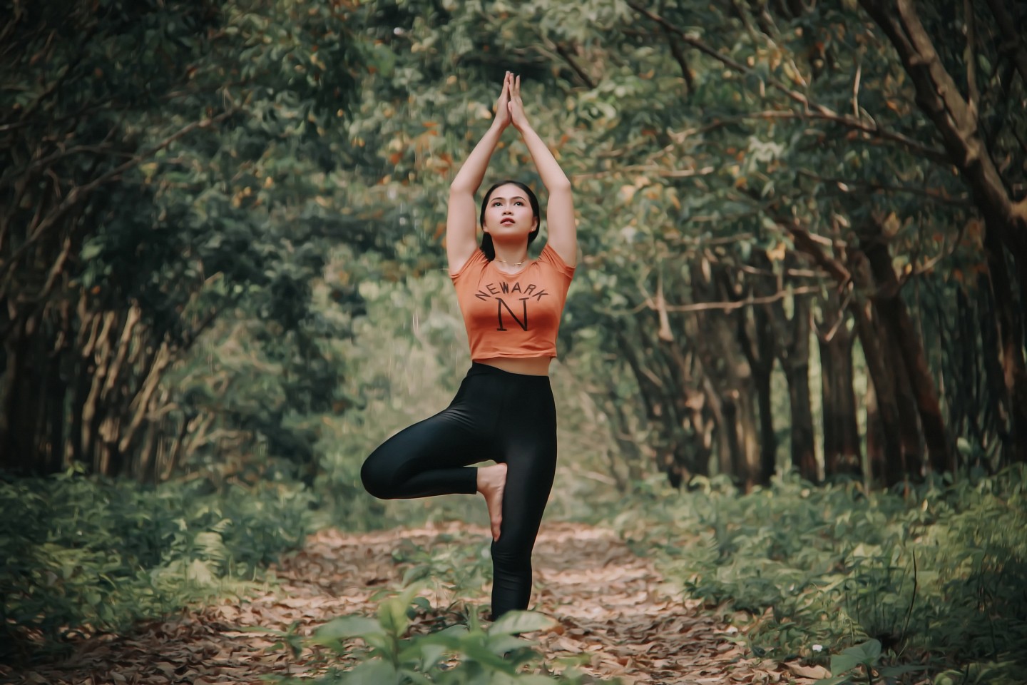 woman doing yoga in the woods