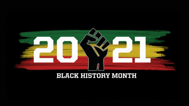 black background with the date "2021" written on top of green, yellow and red paint with a closed fist in the middle