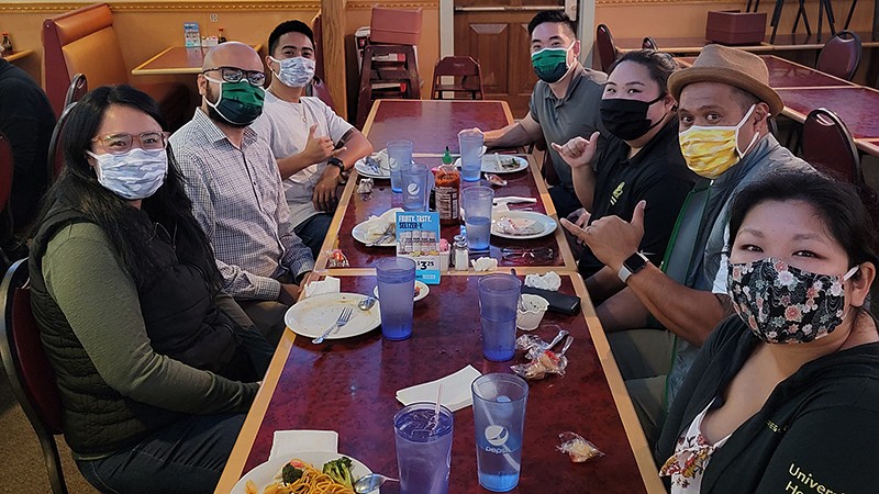 the ADPI strategies group posing for a photo and wearing masks during a group lunch