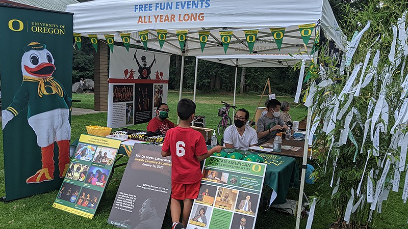 child visits booth at Asian Celebration event