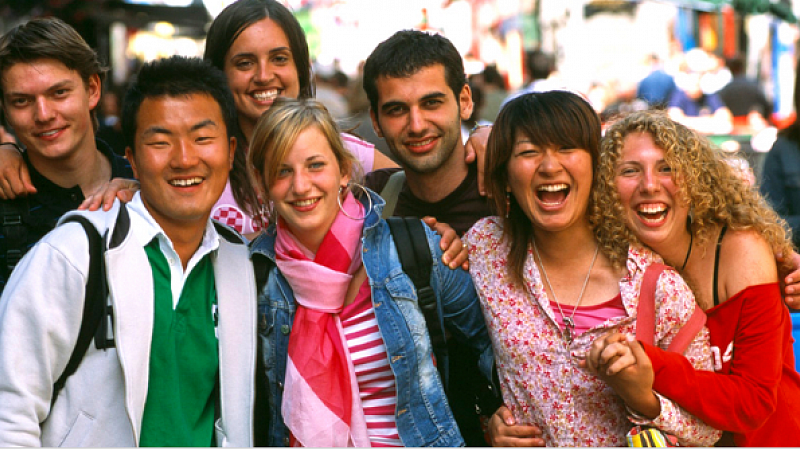 Conversations about Culture cover photo of group of young people from different cultures laughing together posing outside