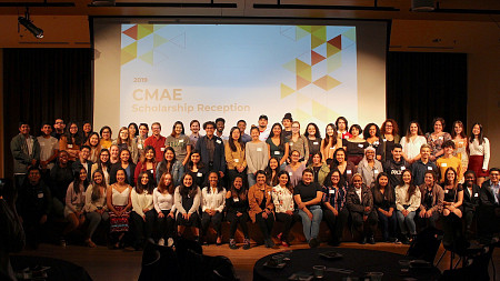 Large group of scholarship recipients on a stage at the 2019 cmae scholarship receptin