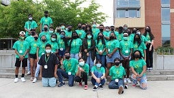 Oregon Young Scholars Program OYSP 2021 Oregon Young Scholars program students standing outside in a group with green t-shirts